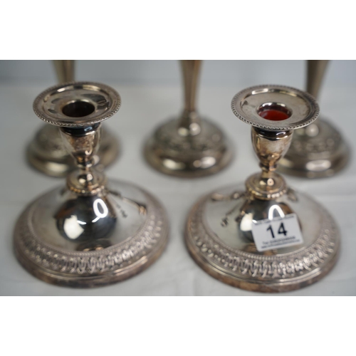 14 - A pair of silver plated candlesticks and three more.