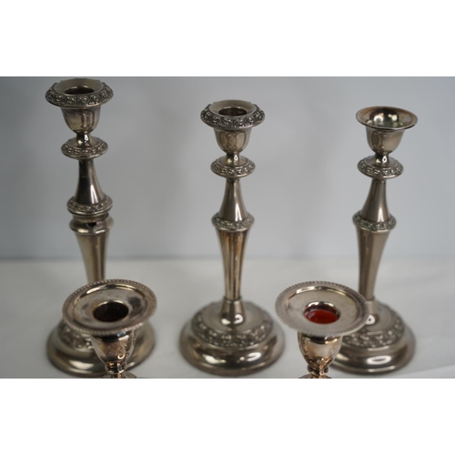 14 - A pair of silver plated candlesticks and three more.