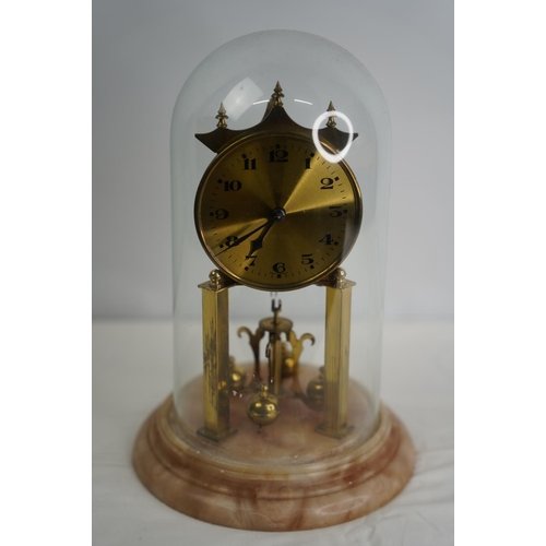 24 - A stunning West German anniversary clock on a marble base and glass dome.