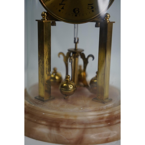 24 - A stunning West German anniversary clock on a marble base and glass dome.