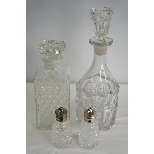 35 - A pair of Waterford crystal condiments and two pressed glass decanters.