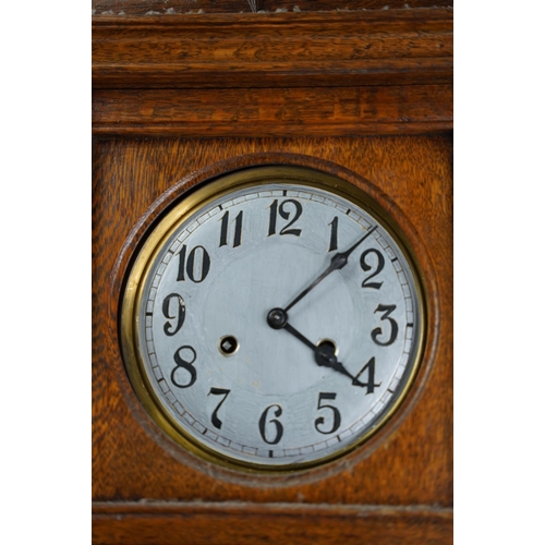 38 - A vintage oak cased wall clock.