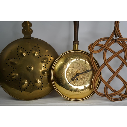 4 - A vintage carpet beater and two brass bed warmers.