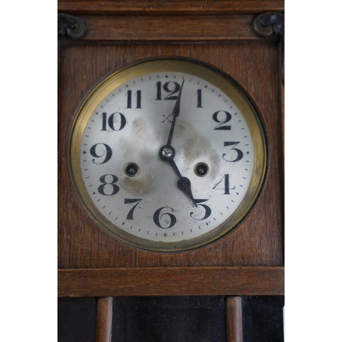 44 - A vintage oak cased wall clock.