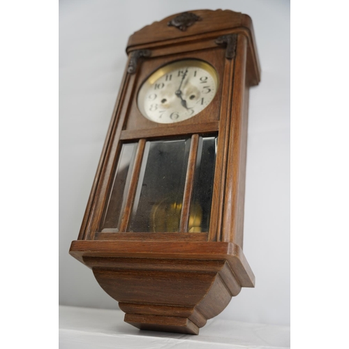 44 - A vintage oak cased wall clock.