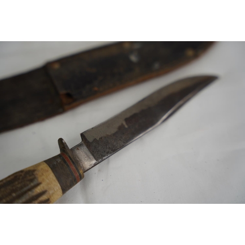 72 - A vintage knife and leather sheaf.