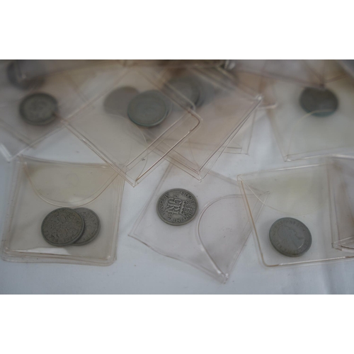 83 - A lot of six pence coins in presentation wallets and other coinage.