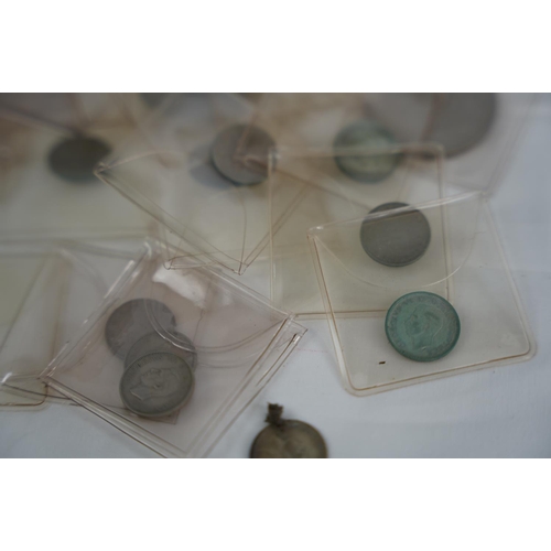 83 - A lot of six pence coins in presentation wallets and other coinage.