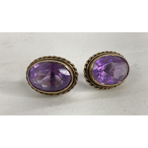 141 - A pair of sterling silver & amethyst earrings.