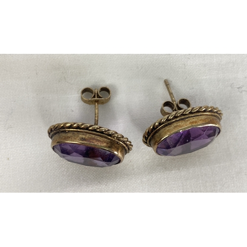 141 - A pair of sterling silver & amethyst earrings.