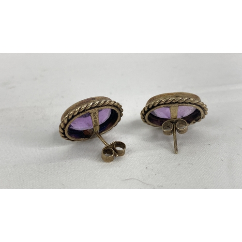 141 - A pair of sterling silver & amethyst earrings.