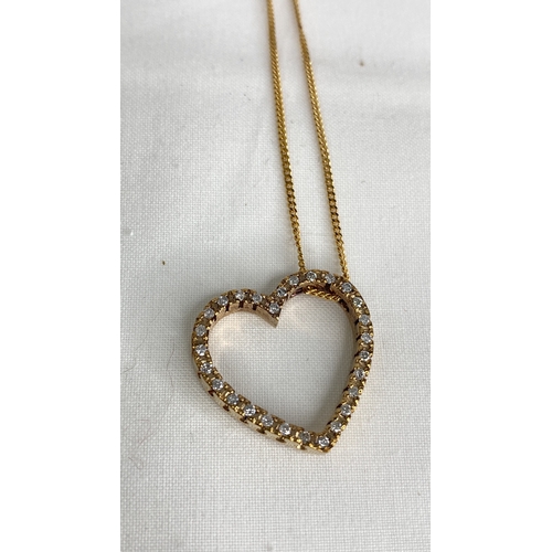 147 - A 9ct gold diamond heart shaped pendant and 16