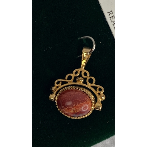 148 - A 9ct gold lapis & agate revolving fob.