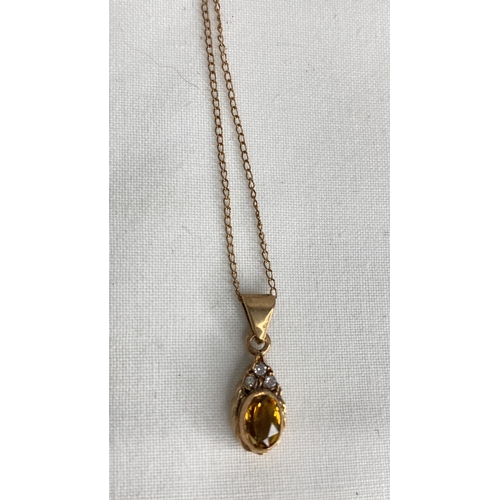 155 - A 9ct gold citrine and diamond pendant and 16