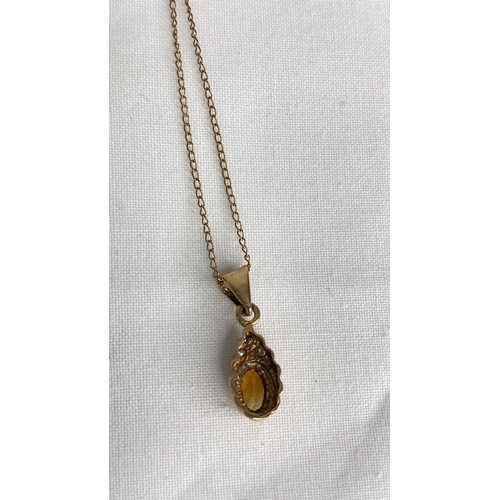 155 - A 9ct gold citrine and diamond pendant and 16