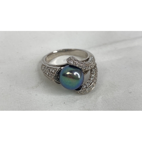 157 - A Sterling silver and fresh water pearl CZ ring, size P.