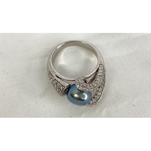 157 - A Sterling silver and fresh water pearl CZ ring, size P.