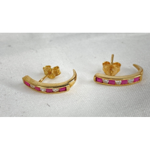 180 - A pair of gold ruby and diamond earrings.