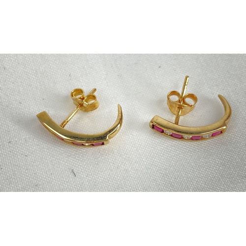 180 - A pair of gold ruby and diamond earrings.