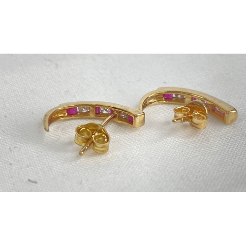 180 - A pair of gold ruby and diamond earrings.