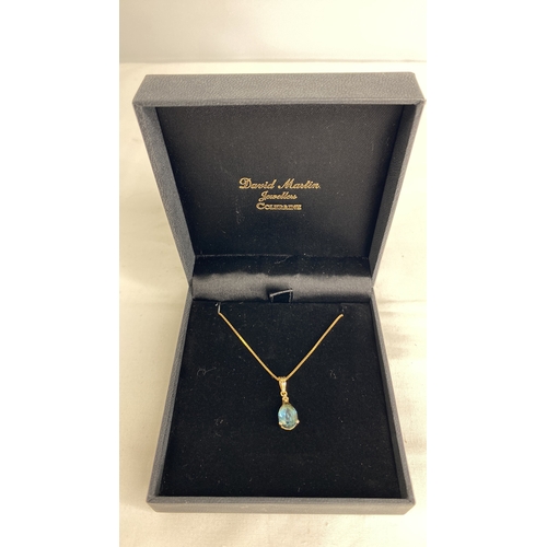 186 - A 14ct gold London blue topaz and diamond pendant on a 18