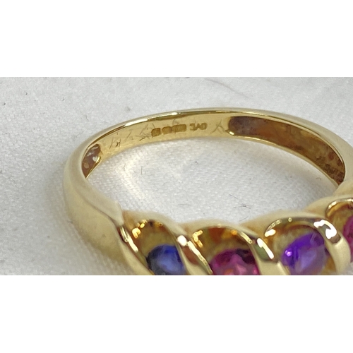 190 - A 9ct gold ring set with sapphire, ruby and amethyst.