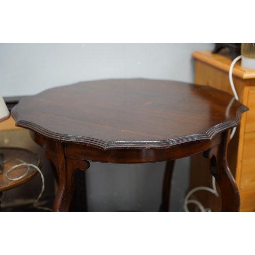 114 - A mahogany table with undershelf.