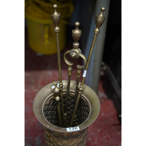 132 - A brass umbrella/ stick stand & fireside companion set.