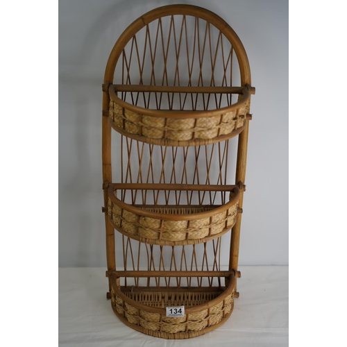 134 - A vintage rattan and wicker wall unit.