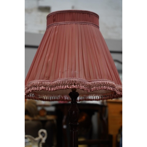 225 - A mahogany standard lamp and shade.