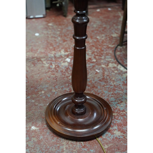 225 - A mahogany standard lamp and shade.