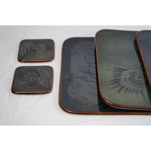 240 - A ceramic set of placemats and coasters with leaf patterned design.