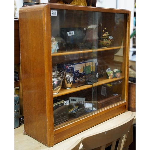 241 - A vintage bookcase with sliding glass doors.