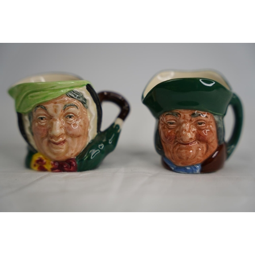 249 - Two miniature Royal Doulton mask jugs.