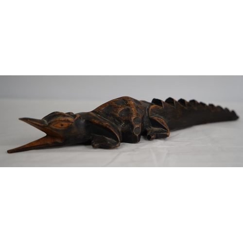 250 - A hand carved wooden crocodile.