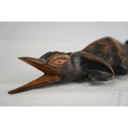 250 - A hand carved wooden crocodile.