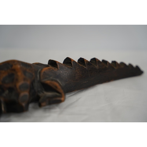 250 - A hand carved wooden crocodile.