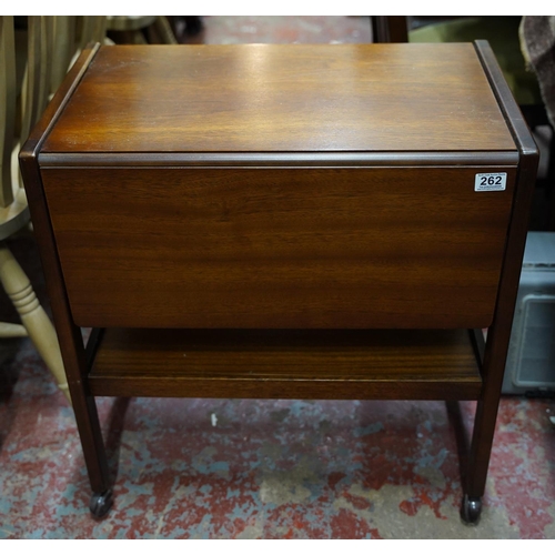 262 - A vintage teak drop leaf table on casters.