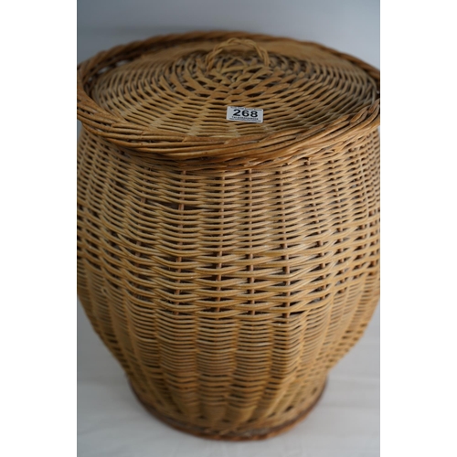 268 - A rattan linen basket and lid.