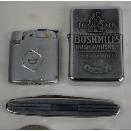 291 - A Bushmills Irish Whiskey lighter, another, penknife and two collectors coins.