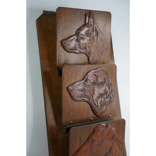 324 - A vintage wooden 'Dogs Head' design letter/newspapers rack.