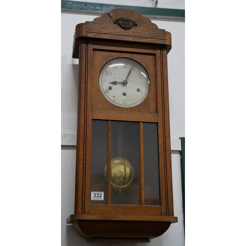 332 - A vintage oak cased wall clock.