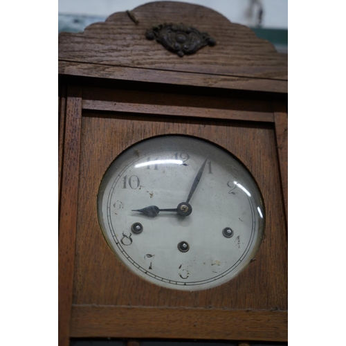 332 - A vintage oak cased wall clock.