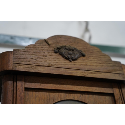 332 - A vintage oak cased wall clock.