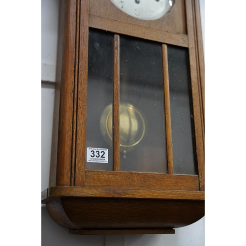 332 - A vintage oak cased wall clock.