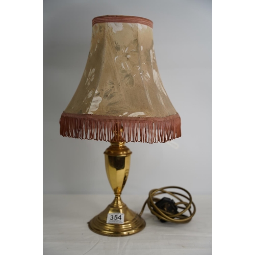 354 - A brass based table lamp and shade.