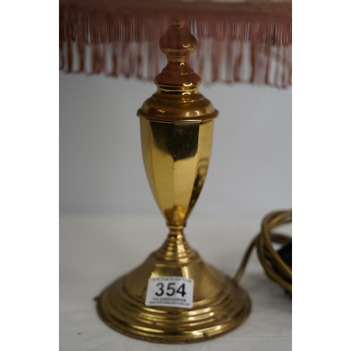 354 - A brass based table lamp and shade.