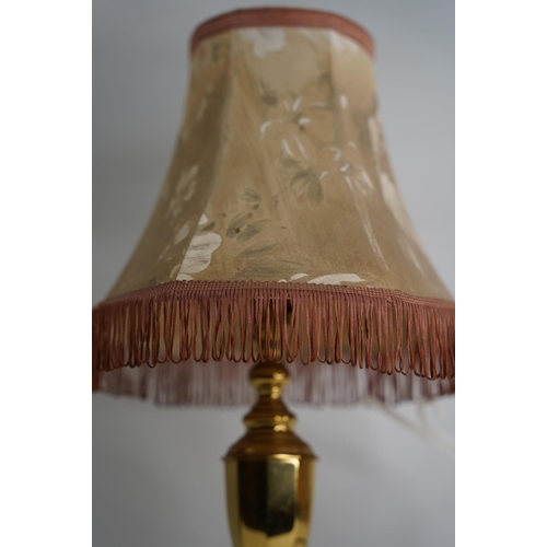 354 - A brass based table lamp and shade.