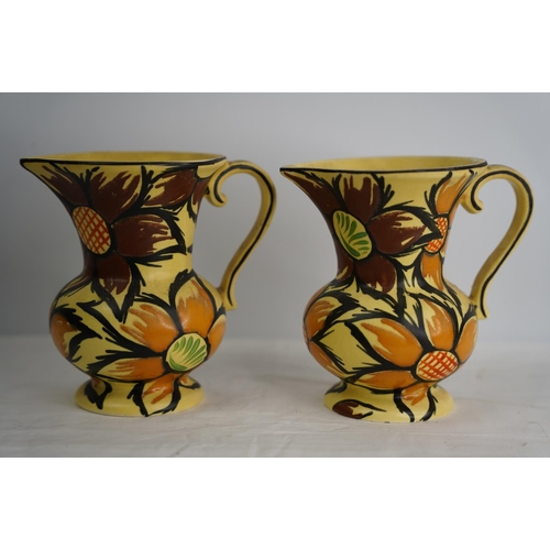 365 - A pair of vintage hand painted jugs.