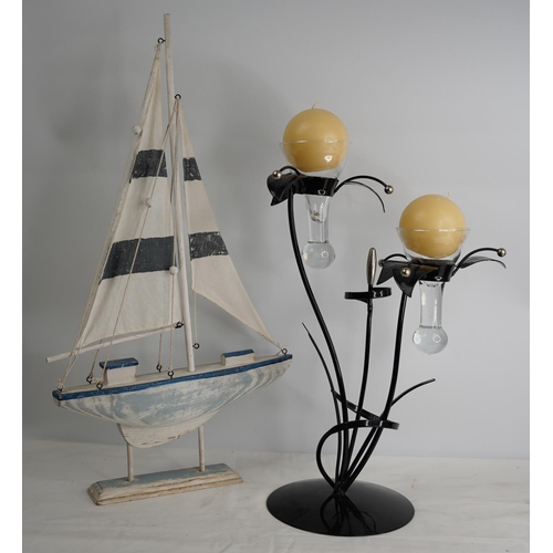 375 - A wooden boat and a metal candle holder.